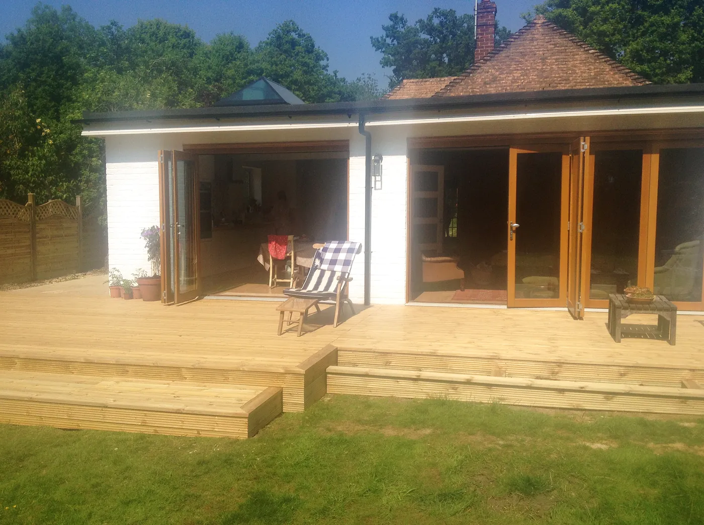 The finished bungalow with a wide rear extension, bifold doors and a new deck