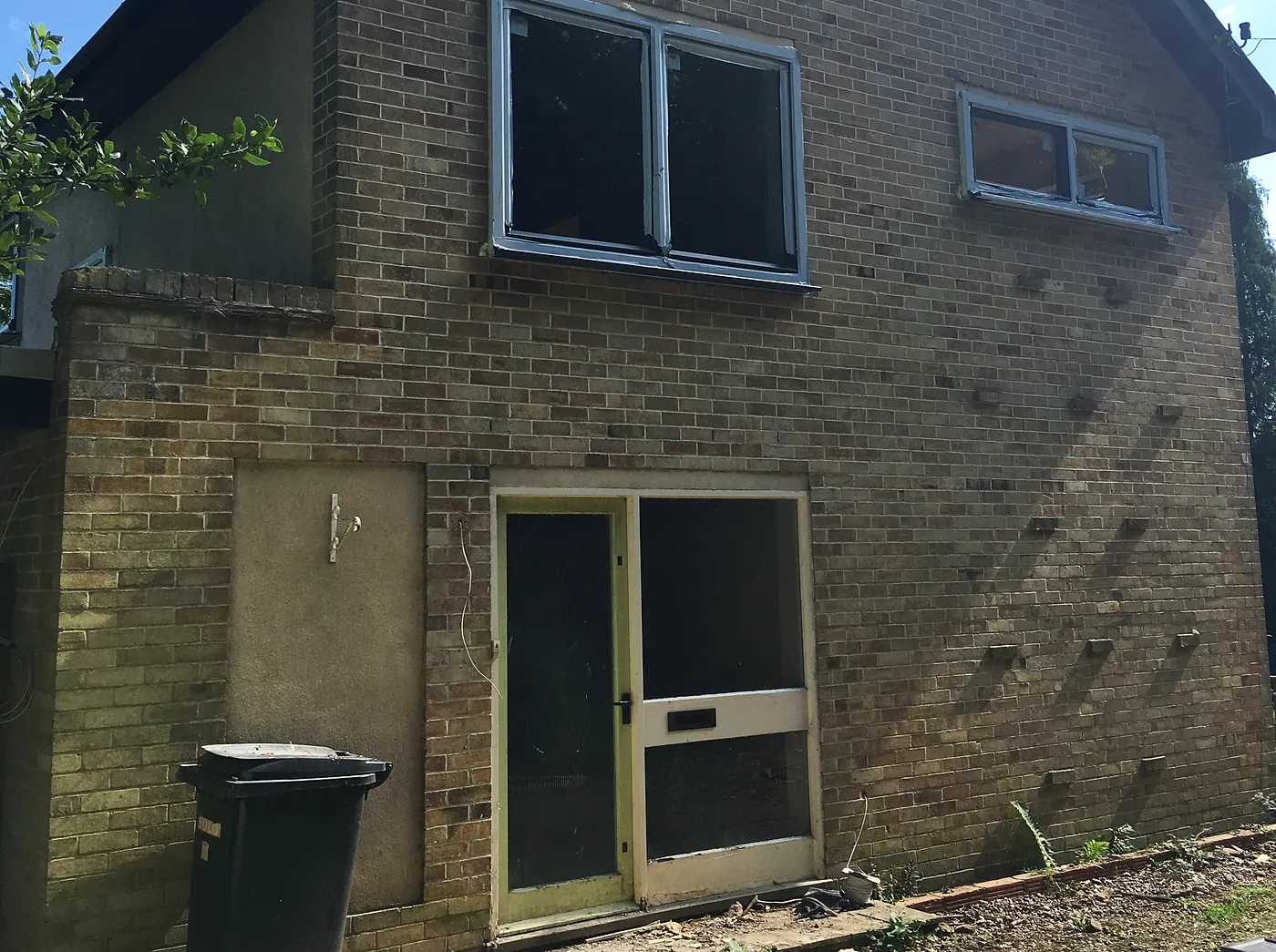 The 1950s house before work started, empty and boarded up