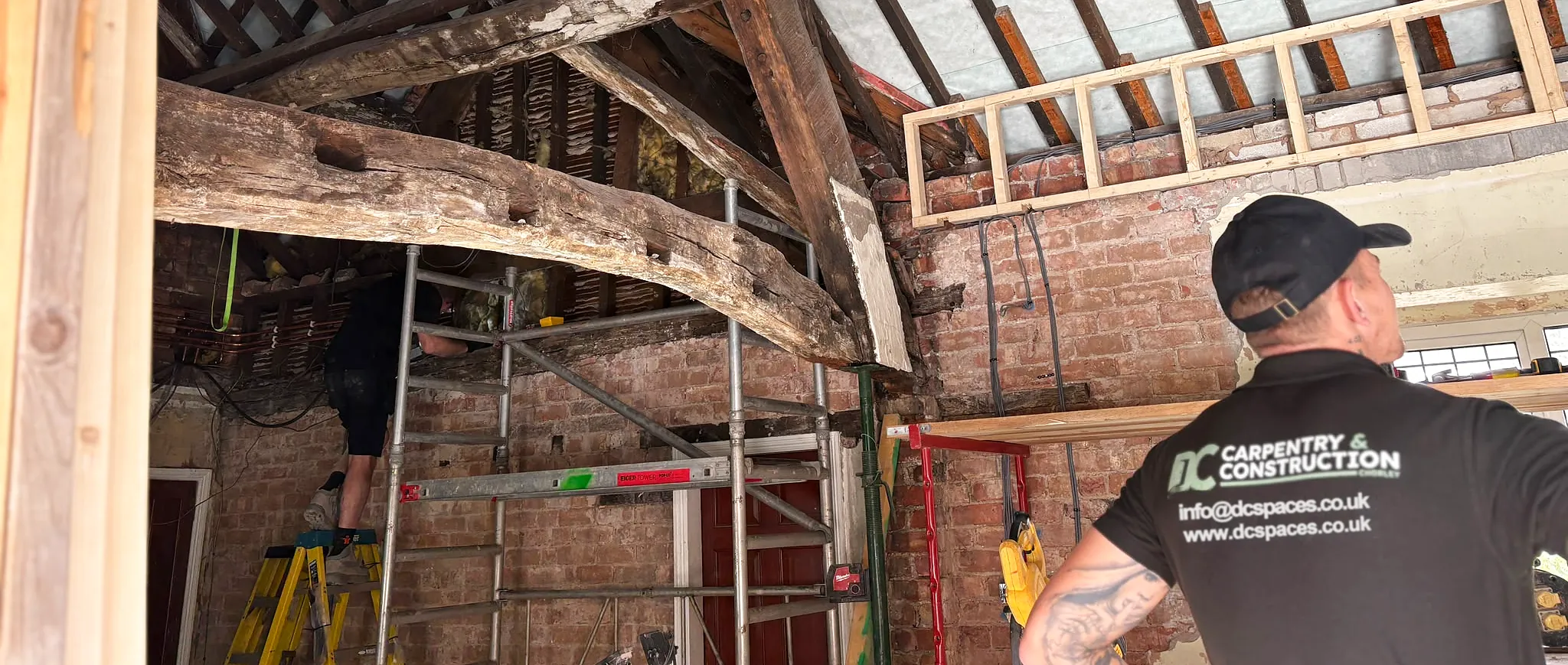 One of the DC Carpentry & Construction team at work under the old oak beams of a period house