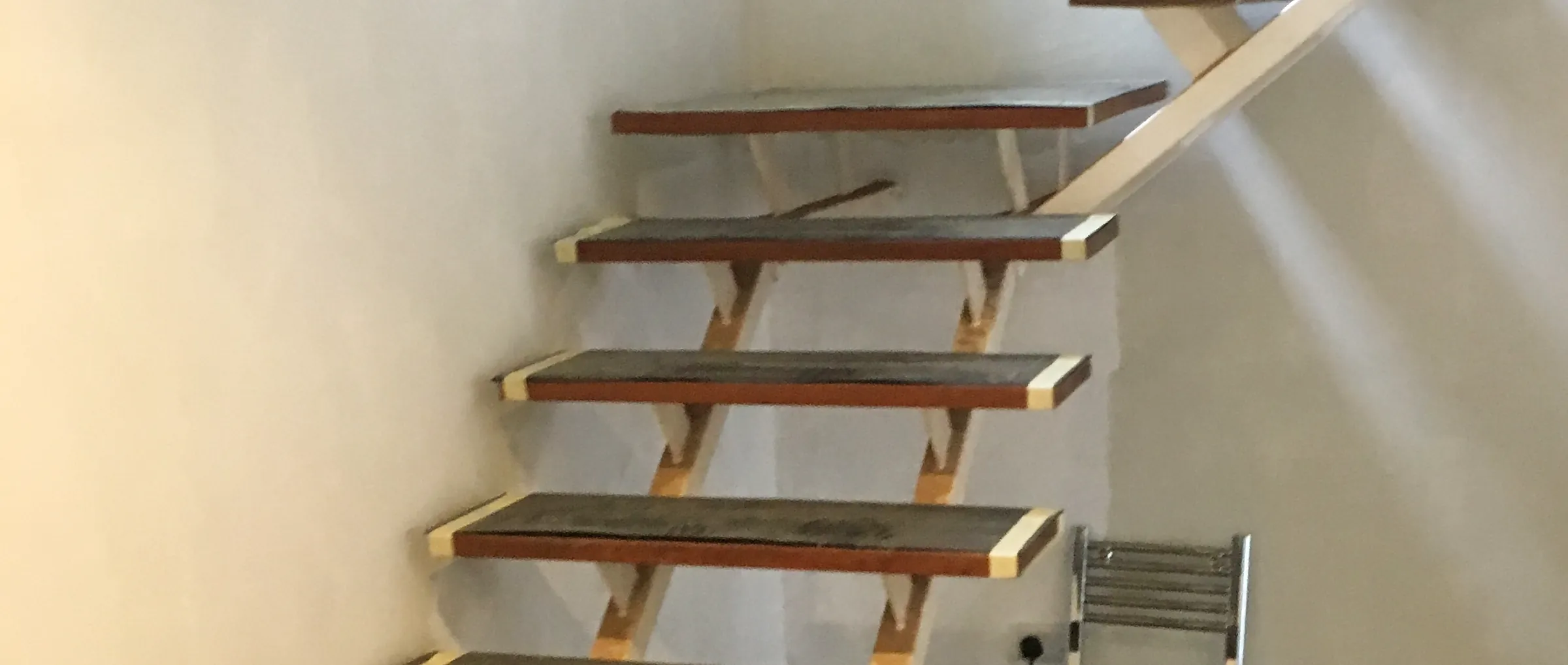 An open-tread staircase being fitted