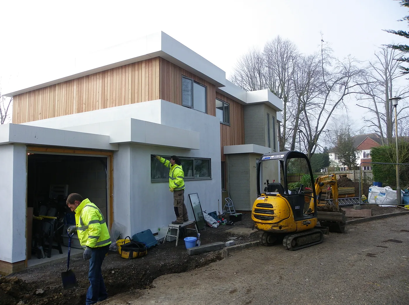 Cedar cladding and white render going on at the front
